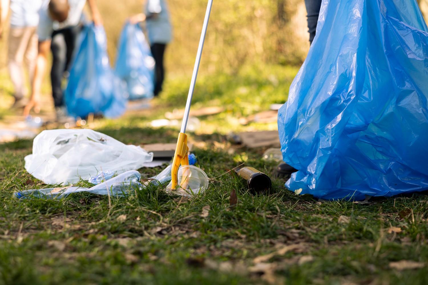 activist using claw tool collect rubbish plastic junk from ground 2