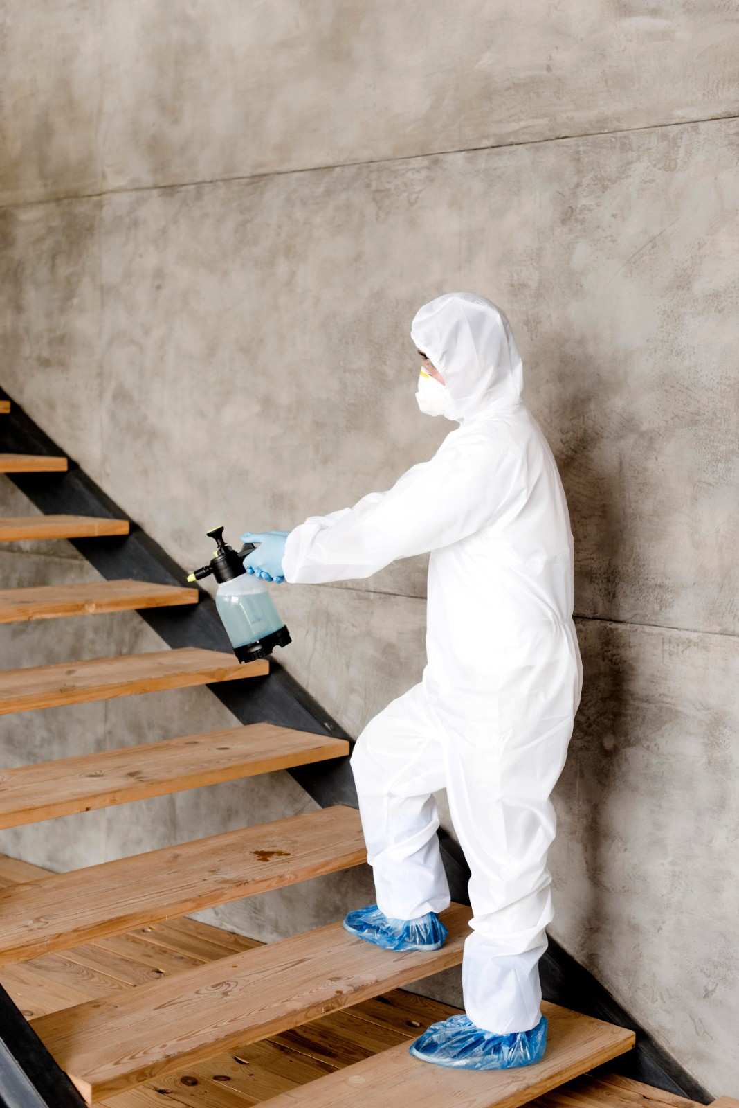 side view man disinfecting stairs 1